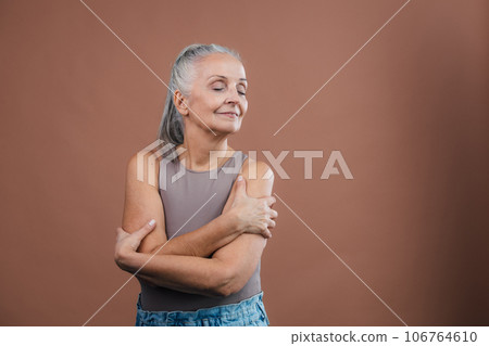 Waist up portrait of beautiful senior woman with closed eyes. 106764610