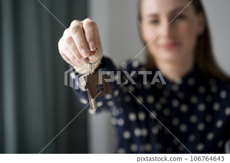 Close-up purchase of real estate. The realtor shows the keys. Close-up of the hand and documents. The concept of leasing and mortgages. Close-up purchase of real estate. The realtor shows the keys. Close-up of the hand and documents. The concept of leasing and mortgages. 106764643