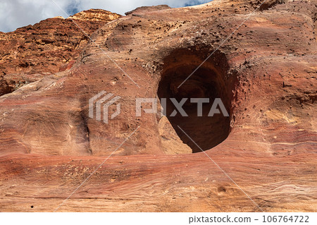 View of the caves and dwellings carved into the sandstone rock. Petra, Jordan. View of the caves and dwellings carved into the sandstone rock. Petra, Jordan. 106764722