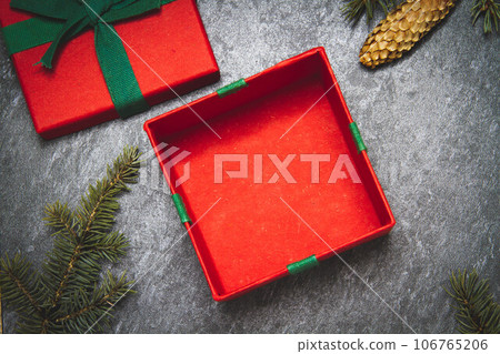 Gift box on a black background. New Year's gift top view. Red and green boxes. Gift box on a black background. New Year's gift top view. Red and green boxes. 106765206