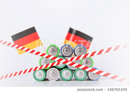 Battery. A lot of batteries on the background of the flag of the country. Battery. A lot of batteries on the background of the flag of the country. 106765209