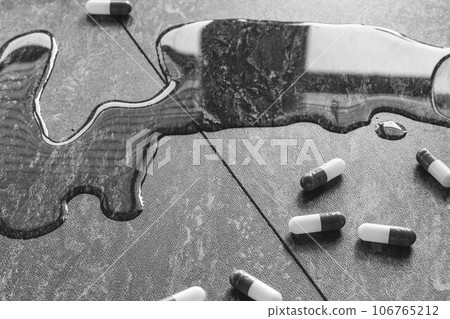 Tablets. Dropping pills and a glass of water from the hands. 106765212