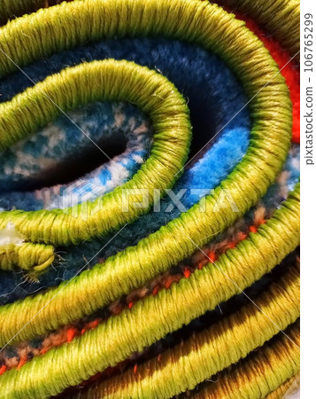 Roll of carpet with overlock close-up. Floor coverings. 106765299