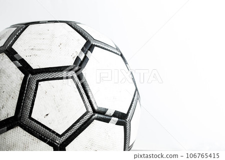 Dirty soccer ball close-up on a white background. 106765415