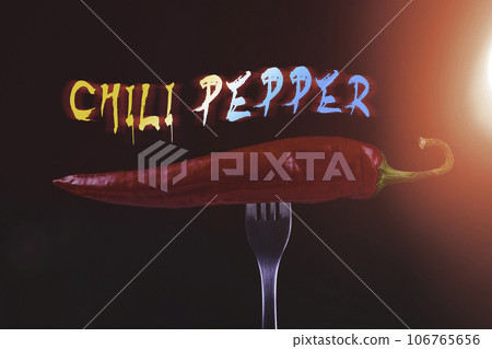 Hot chili peppers on fork. Extra spicy. Mexican food with pepper. Seasonings and spices. Hellish seasoning. 106765656