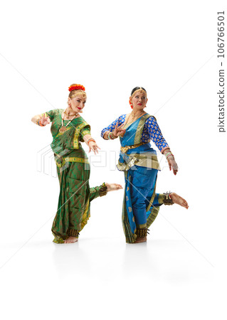 Sattriya dance. Women, in beautiful traditional indian dresses dancing against white studio background 106766501