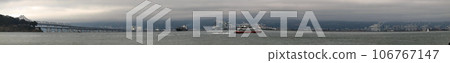 Panoramic of Ferry racing by the Bay bridge and the east bay 106767147