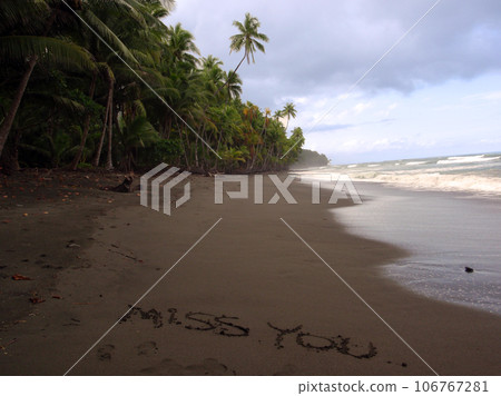 'Miss You' written in the sand on a remote beach 106767281