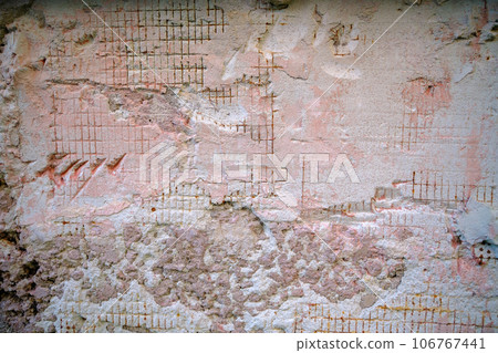 Reinforced concrete with damaged and rusty steel reinforcement. Old distressed wall texture background, steel bars and mesh visible corrosion Reinforced concrete with damaged and rusty steel reinforcement. Old distressed wall texture background, steel bars and mesh visible corrosion 106767441