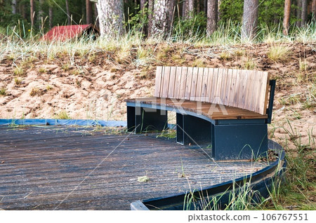 Recreation area by Lake Peipus. A comfortable wooden bench overlooking the lake Recreation area by Lake Peipus. A comfortable wooden bench overlooking the lake 106767551