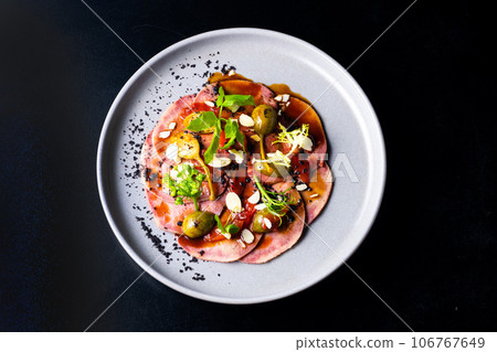 Beef tongue with sauce and vegetables on a white plate Beef tongue with sauce and vegetables on a white plate 106767649
