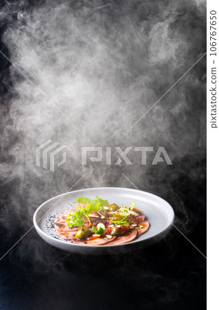 Beef tongue with sauce and vegetables on a white plate 106767650