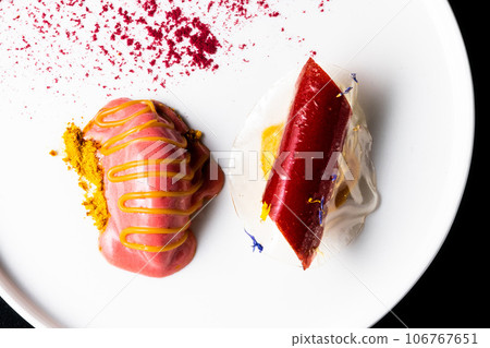 Italian Sicilian cannolo dessert closeup on white plate macro with crust and ricotta cheese 106767651