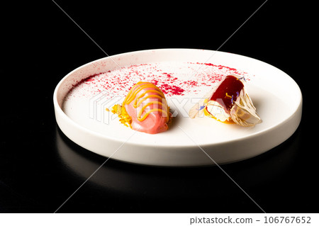 Italian Sicilian cannolo dessert closeup on white plate macro with crust and ricotta cheese 106767652