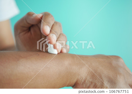 man applying beauty cream onto skin man applying beauty cream onto skin 106767751