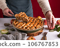 Woman serving a slice of apple pie on a plate, ready to eat Woman serving a slice of apple pie on a plate, ready to eat 106767853