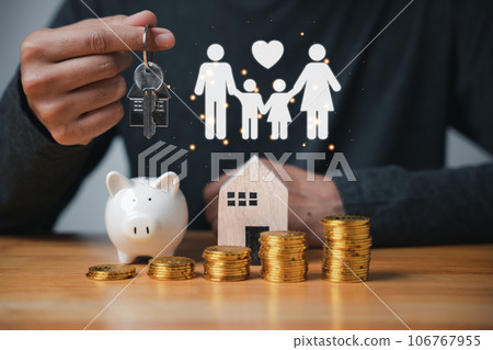 Man holding key and coins with stacked coins depicting rise in interest rates. Planning to save money for a home is a sound financial decision. concept of property investment and wealth accumulation Man holding key and coins with stacked coins depicting rise in interest rates. Planning to save money for a home is a sound financial decision. concept of property investment and wealth accumulation 106767955