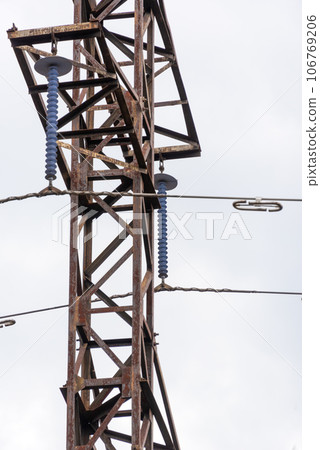 Close-up of a high voltage tower with loop type insulators and dampers. 106769206