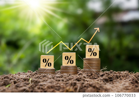 Percentage sign on wooden cube and red arrow. Idea for FED considering raising interest rates. World economy Percentage sign on wooden cube and red arrow. Idea for FED considering raising interest rates. World economy 106770033
