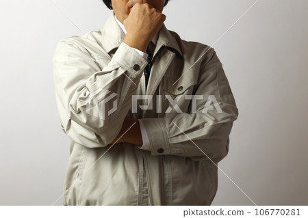A man in work clothes thinking A man in work clothes thinking 106770281