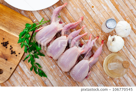 Fresh raw meat quails ready for cooking on slate board 106770545