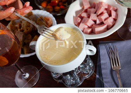 Cheese fondue with bread and snacks Cheese fondue with bread and snacks 106770665