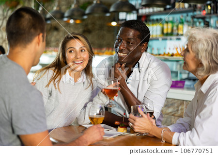 Portrait of smiling females and males having fun. Focus on man and woman in center Portrait of smiling females and males having fun. Focus on man and woman in center 106770751