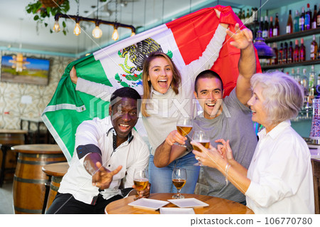 Diverse group celebrating with Mexican flag Diverse group celebrating with Mexican flag 106770780