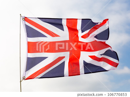 Flag of united kingdom flying with pride with blue sky as background 106770853