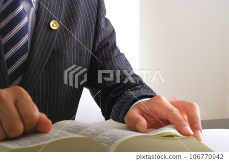 Male lawyer reading the complete book of the Six Codes Male lawyer reading the complete book of the Six Codes 106770942