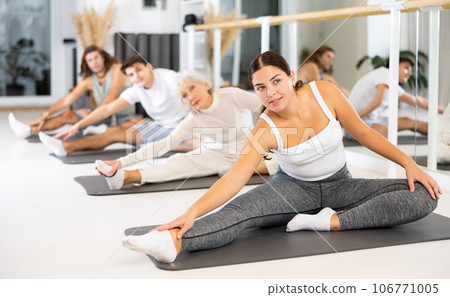 Young woman practicing pilates in gym room 106771005