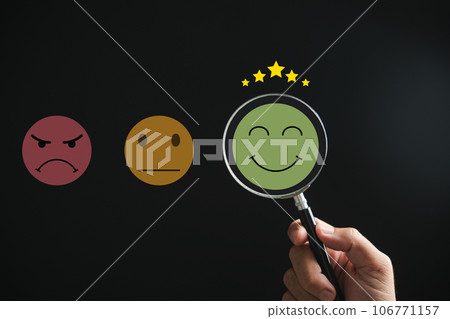 Magnifying glass discovers smiley face icon. Customer satisfaction and evaluation after service or marketing survey. Magnification, satisfaction, reputation, corporate, customer, emotion depicted. 106771157