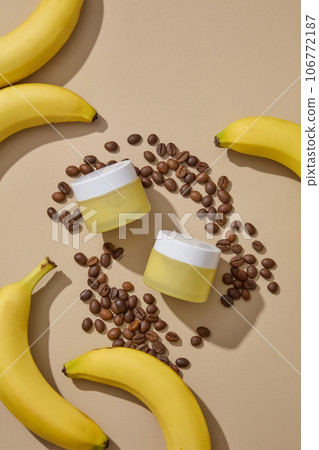 Many roasted coffee beans are featured with bananas and two jars in yellow color. The composition of banana and coffee has many benefits for skin Many roasted coffee beans are featured with bananas and two jars in yellow color. The composition of banana and coffee has many benefits for skin 106772187