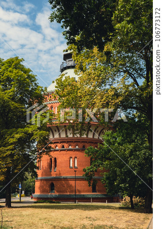 Old brick water tower in Bydgoszcz. The Water Tower in Bydgoszcz, Poland, historic city landmark and viewpoint, Neo-Gothic architecture. 106773172