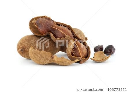Tamarind whole and cracked open on white background 106773331