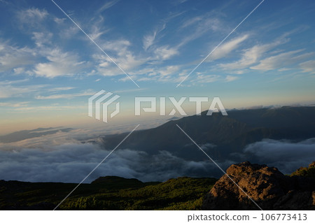 Waterfall clouds at dusk over the ridgeline 106773413