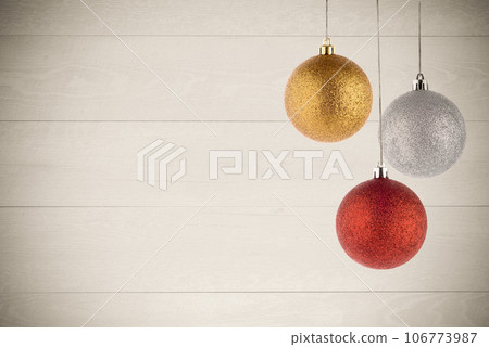Three Christmas Balls Hanging 106773987