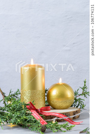 Cristmas candles and tree branches Cristmas candles and tree branches 106774131