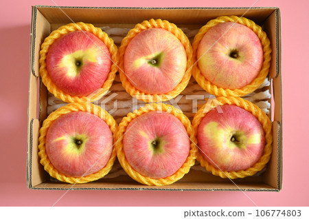 beautiful pink apple in the box on pink background 106774803