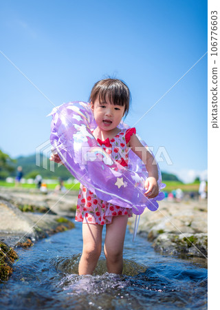 Girl playing in the natural river pool Girl playing in the natural river pool 106776603