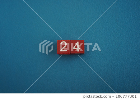Wooden Viva Magenta cubes with number 24 on blue background close-up top view. Concept of date or time. White numbers 24 Wooden Viva Magenta cubes with number 24 on blue background close-up top view. Concept of date or time. White numbers 24 106777301