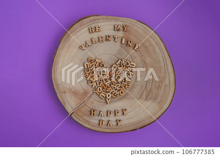 The wooden alphabet in the form of a heart on a tree slice. Valentine's Day 106777385