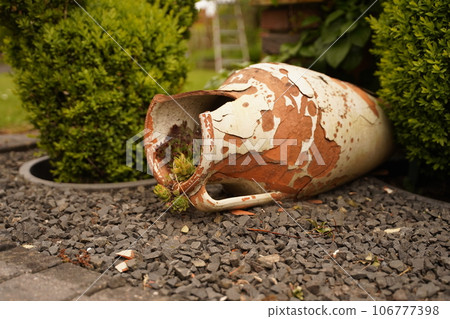 Broken pitcher of ornamental stones 106777398