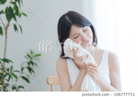 A woman sweating with a towel 106777751