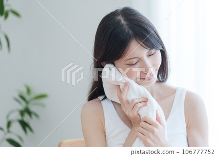 A woman sweating with a towel 106777752