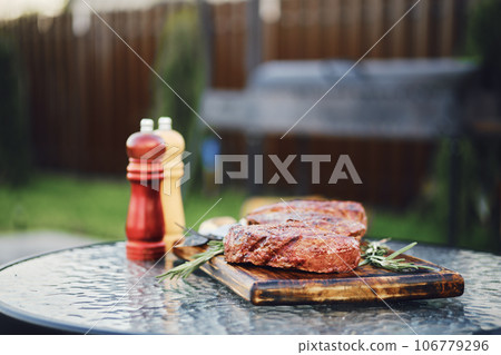 Selective focus photo of grilled striploin steaks on backyard 106779296