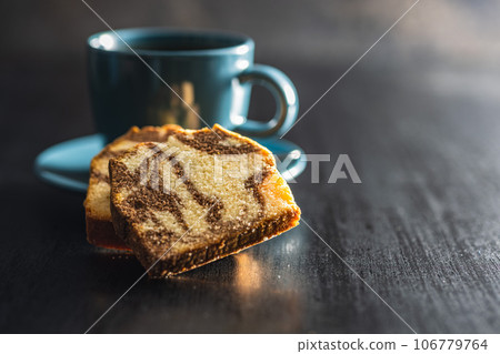 Marble sponge cake and coffee cup. Cake with cocoa and vanilla taste. Marble sponge cake and coffee cup. Cake with cocoa and vanilla taste. 106779764