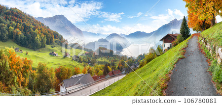 Gorgeous autumn view on suburb of Stansstad city and Lucerne lake with mountaines and fog 106780081