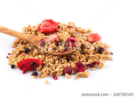 Muesli oat cereals close up background with dry fruits in wooden spoon 106780165