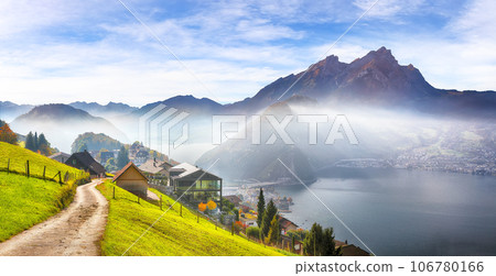 Gorgeous autumn view on suburb of Stansstad city and Lucerne lake with mountaines and fog 106780166